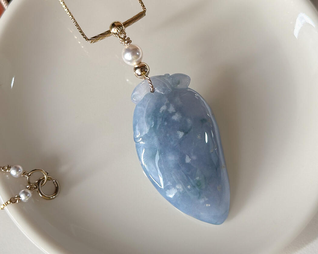 Purple Jadeite Pendant resting on coffee table
