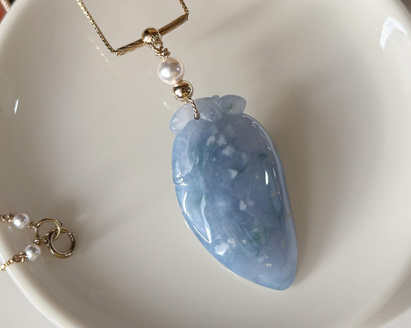 Purple Jadeite Pendant resting on coffee table
