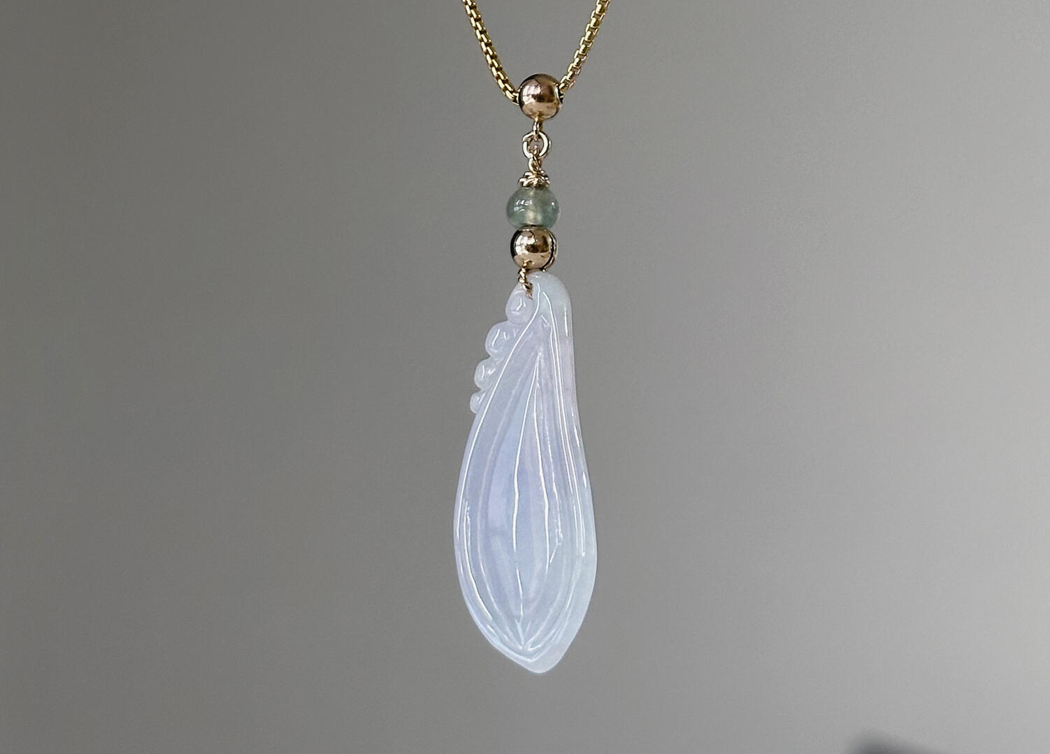 Back of Lavender Tinted Teardrop Shaped Jadeite Pendant hanging natural light