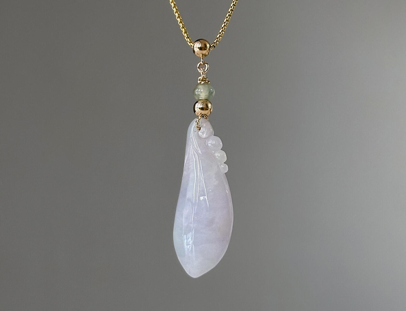 Lavender Tinted Teardrop Shaped Jadeite Pendant hanging