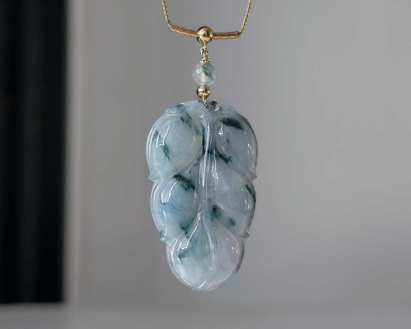 Flora Styled Leaf Jadeite Necklace hanging on a clean background