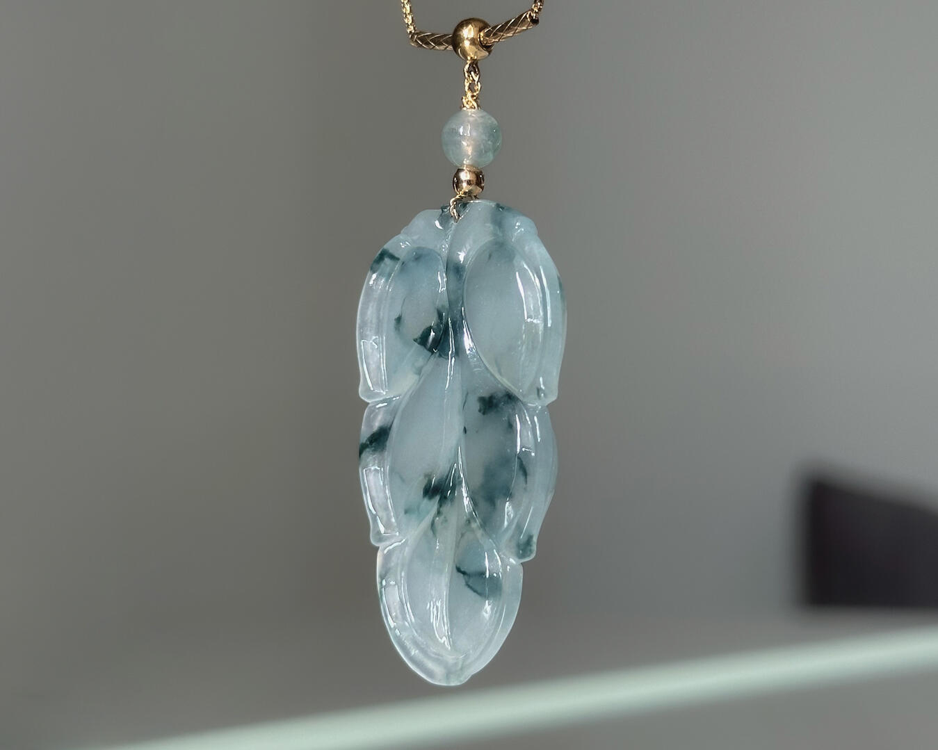 Back of Lavender Tinted Teardrop Shaped Jadeite Pendant hanging natural light