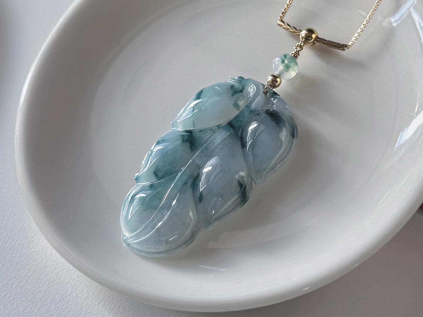 Flora Styled Leaf Jadeite Necklace Lying on table with natural light