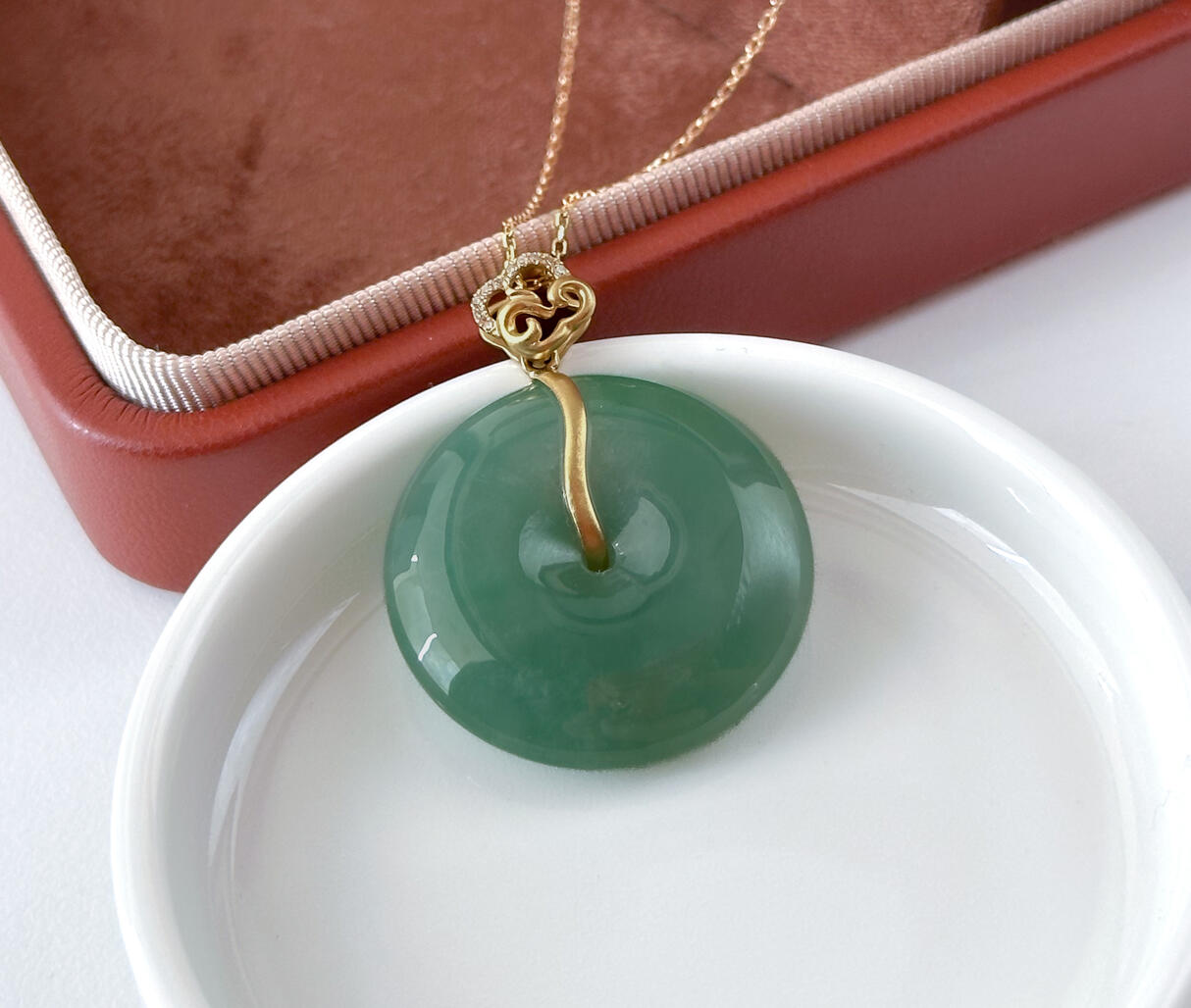 Green Jadeite Doughnut Pendant Bespoke Gold Cloud Bail Lying on Disc
