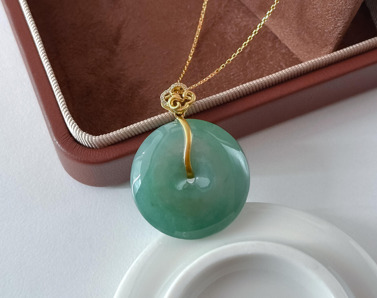 Green Jadeite Doughnut Pendant Bespoke Gold Cloud Bail Angled Natural Light